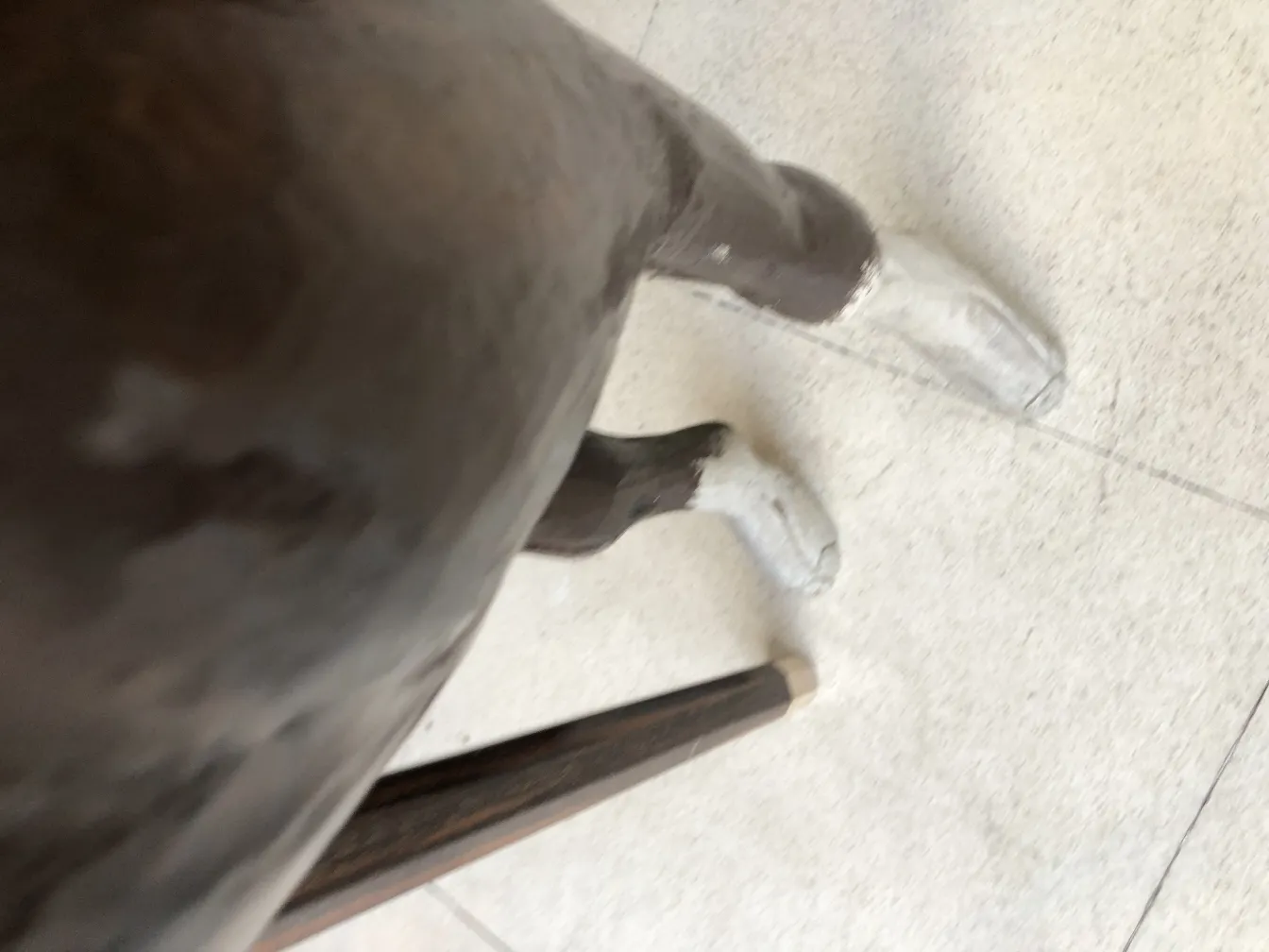 antique llama sculpture with white legs