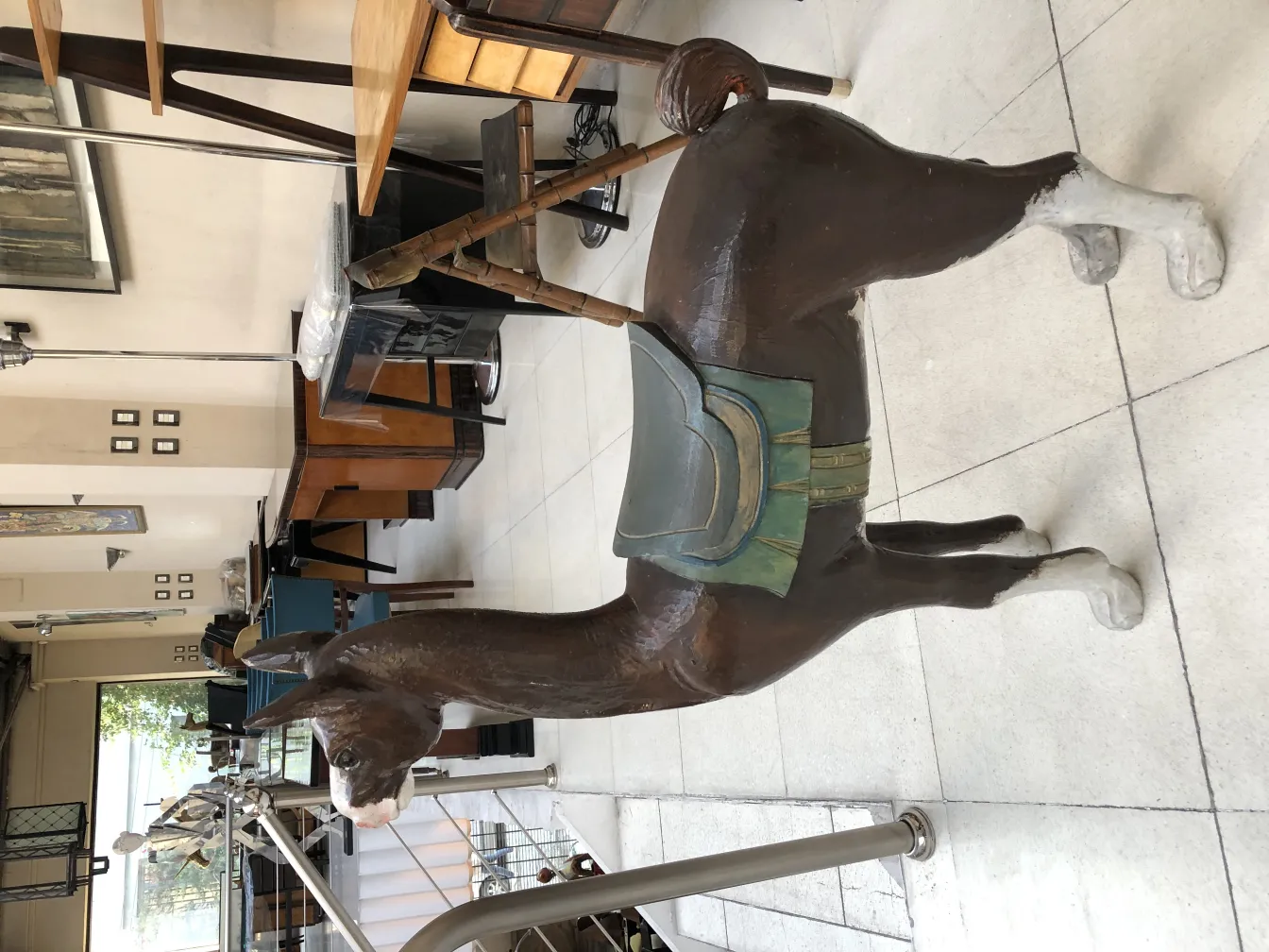 Antique llama sculpture in a furniture setting