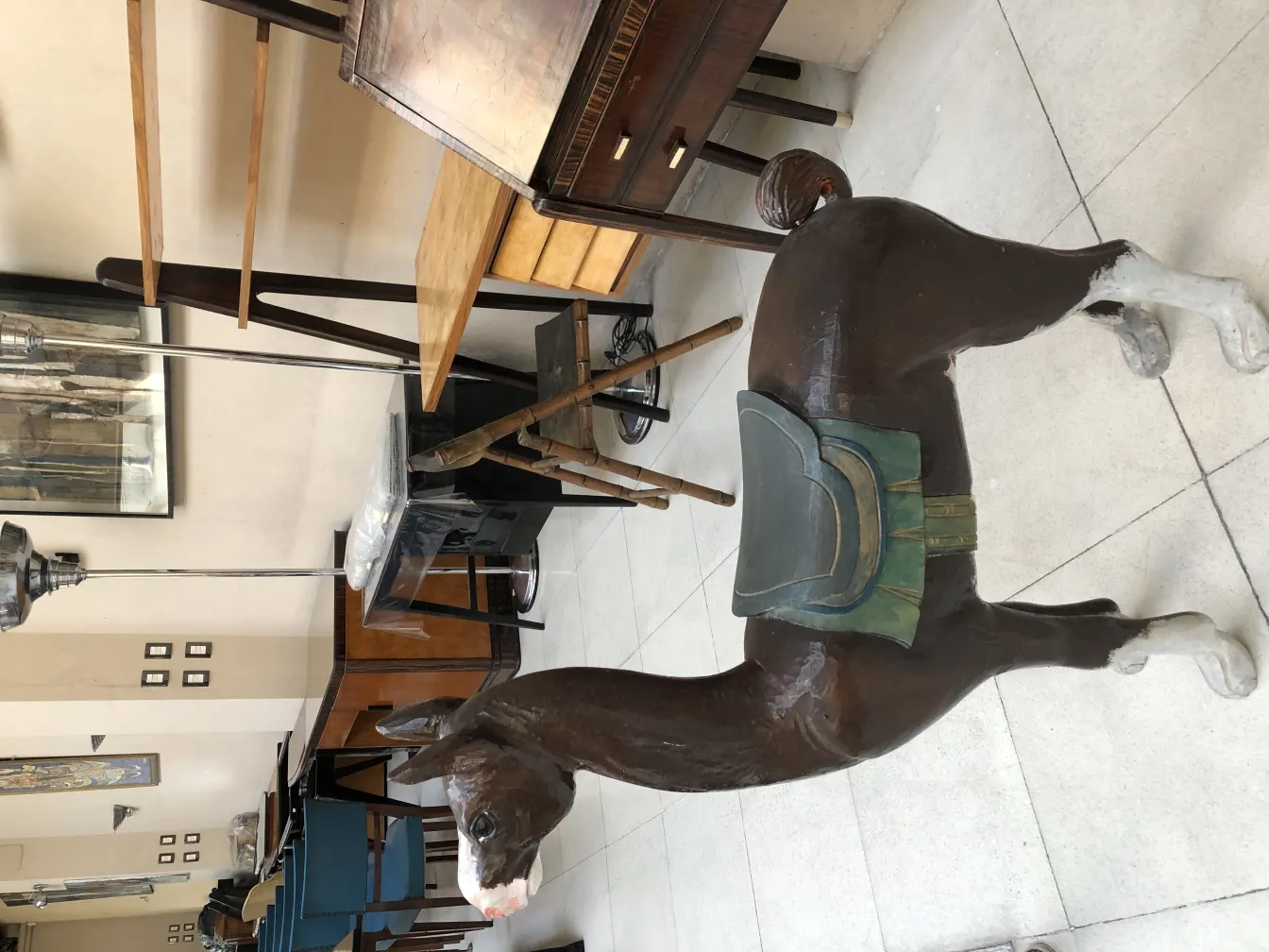 antique sculpture of a llama with a saddle