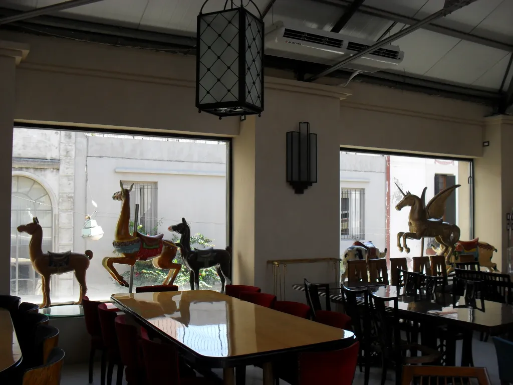 Antique decorative llama sculpture in a bright space.