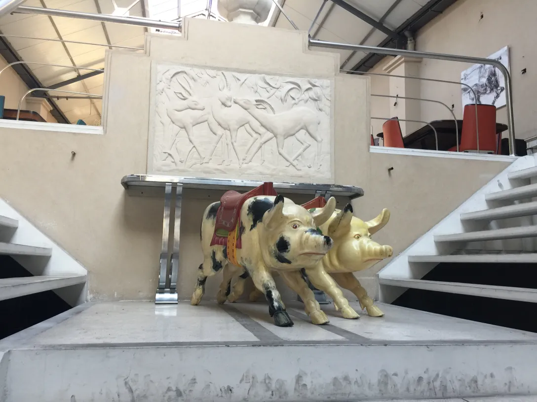 sculpture of an antique pig in a modern setting