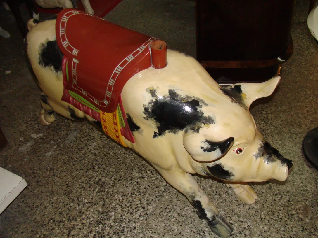 figurine of an antique pig with saddle, light and dark colors