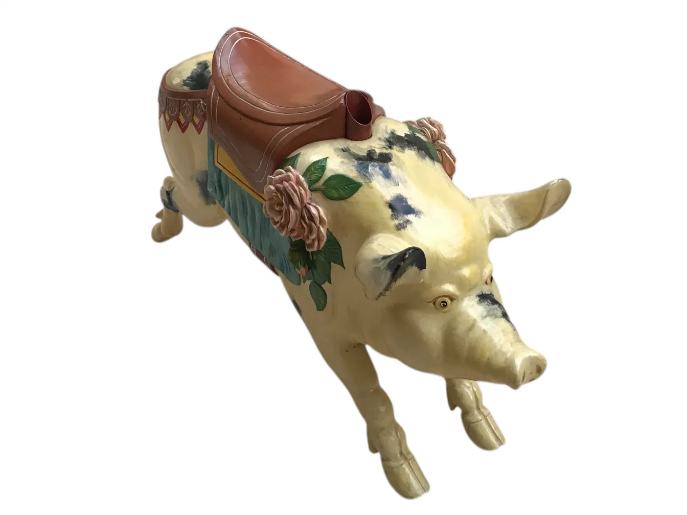 antique pig with floral decorations and saddle