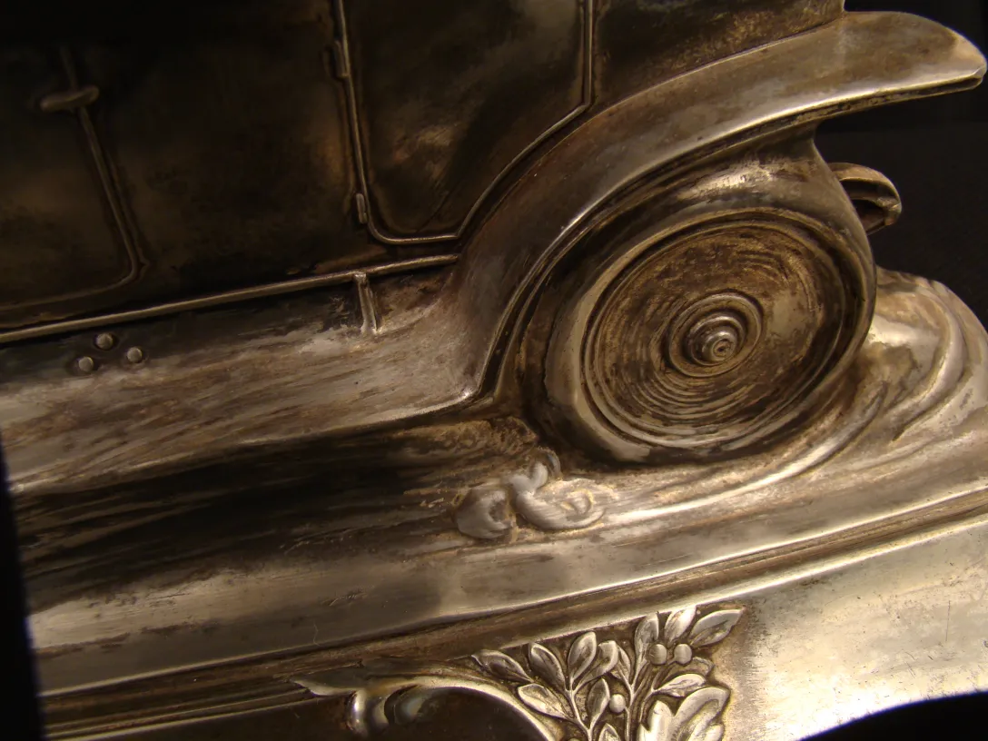 Antique WMF inkwell with detailed floral design.