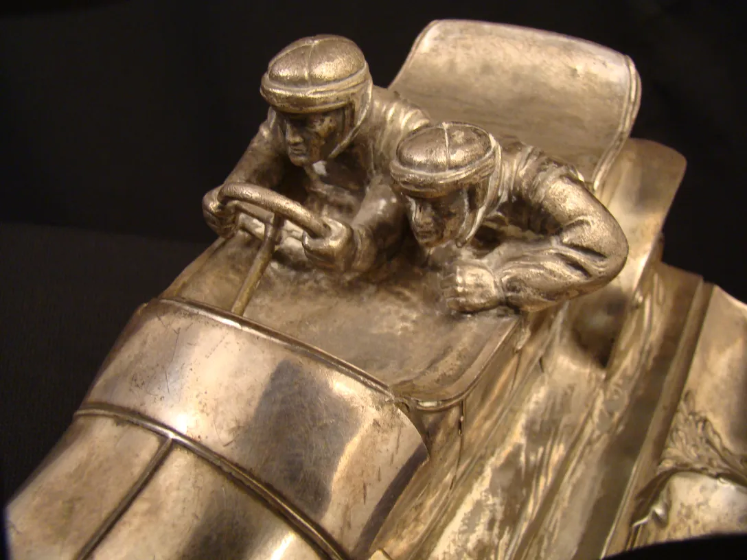 antique WMF inkwell featuring racing details in a dark setting
