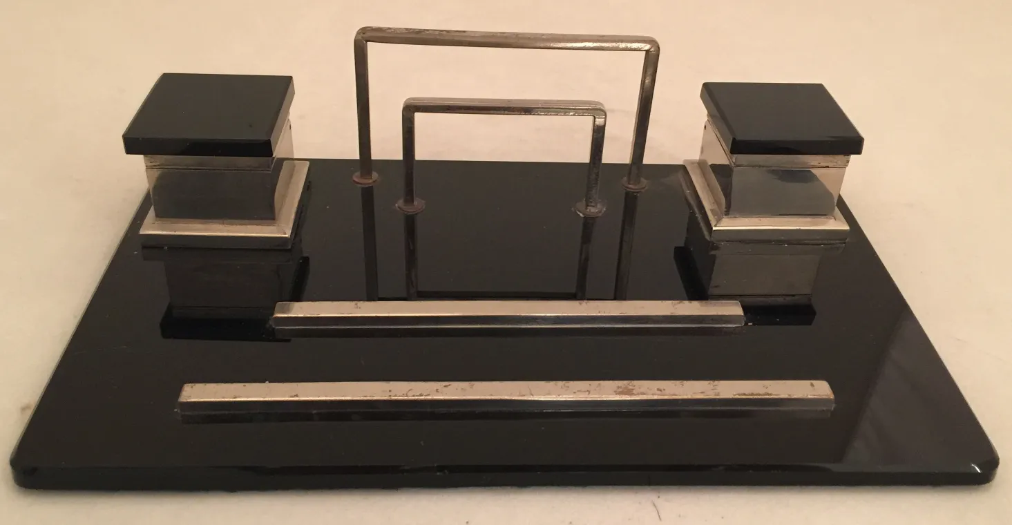 antique inkwell with black lid and elegant base