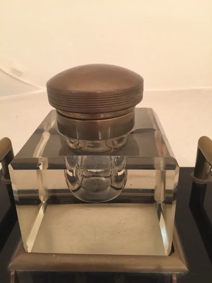 antique inkwell with metal lid and clear glass base, decorated, classic ambiance