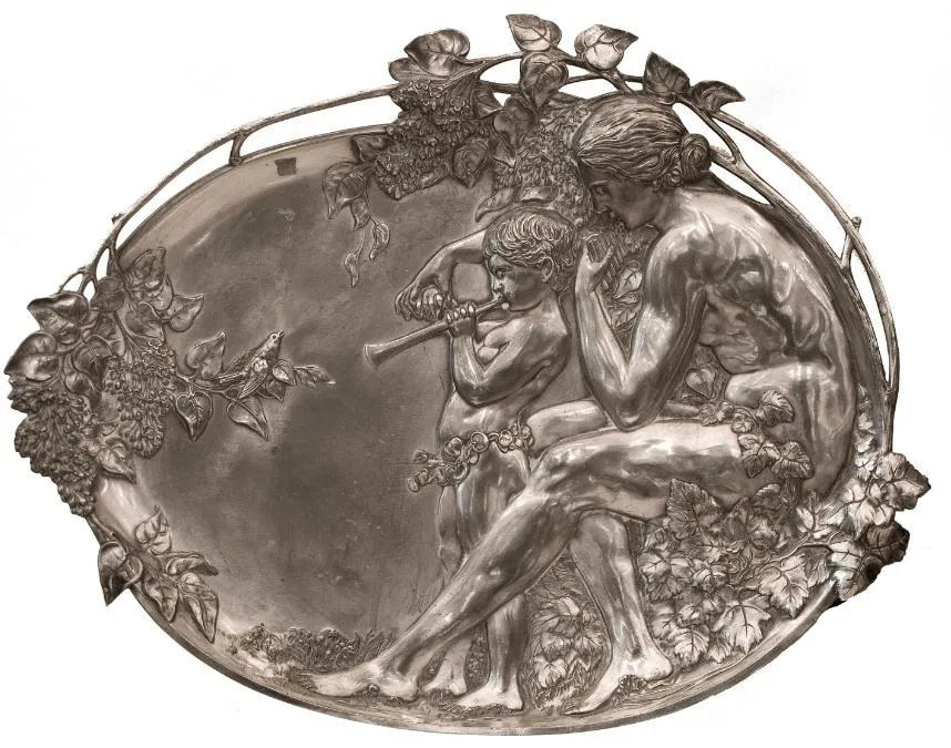 Two antique wall plaques featuring decorative scenes.