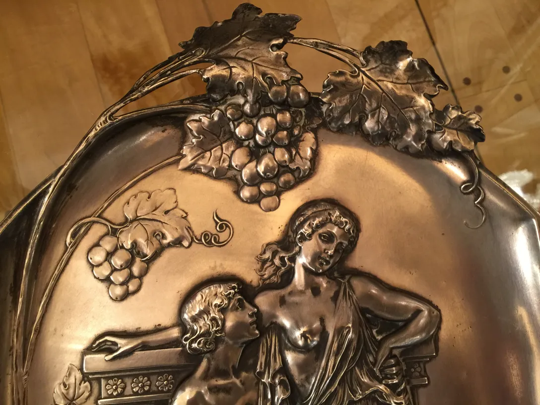 two antique wall plaques featuring grape designs