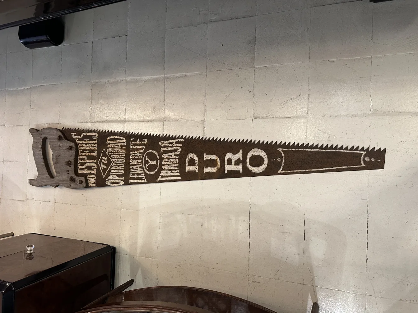 Antique advertising hand saw with printed details and classic shape