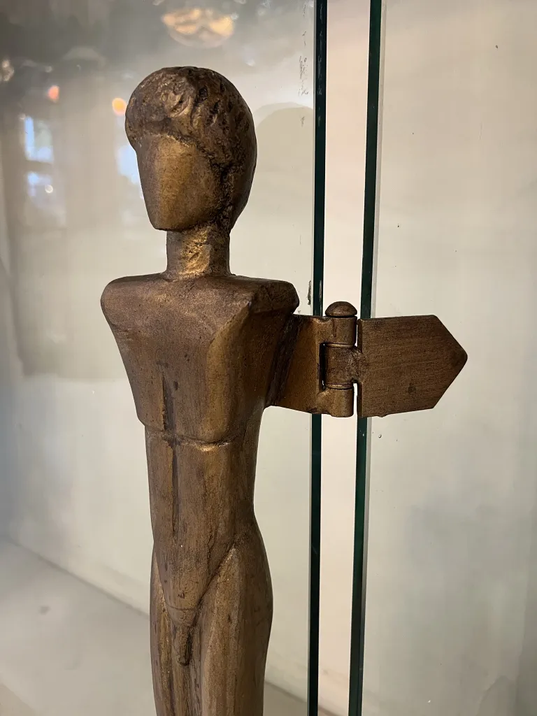 Old fireplace front by Alberto Giacometti featuring a stylized figure and details