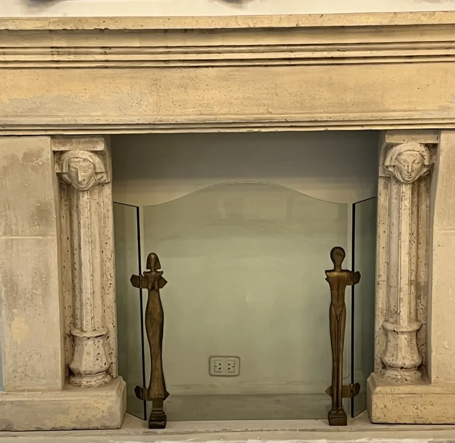 Antique fireplace front with figures at the base.