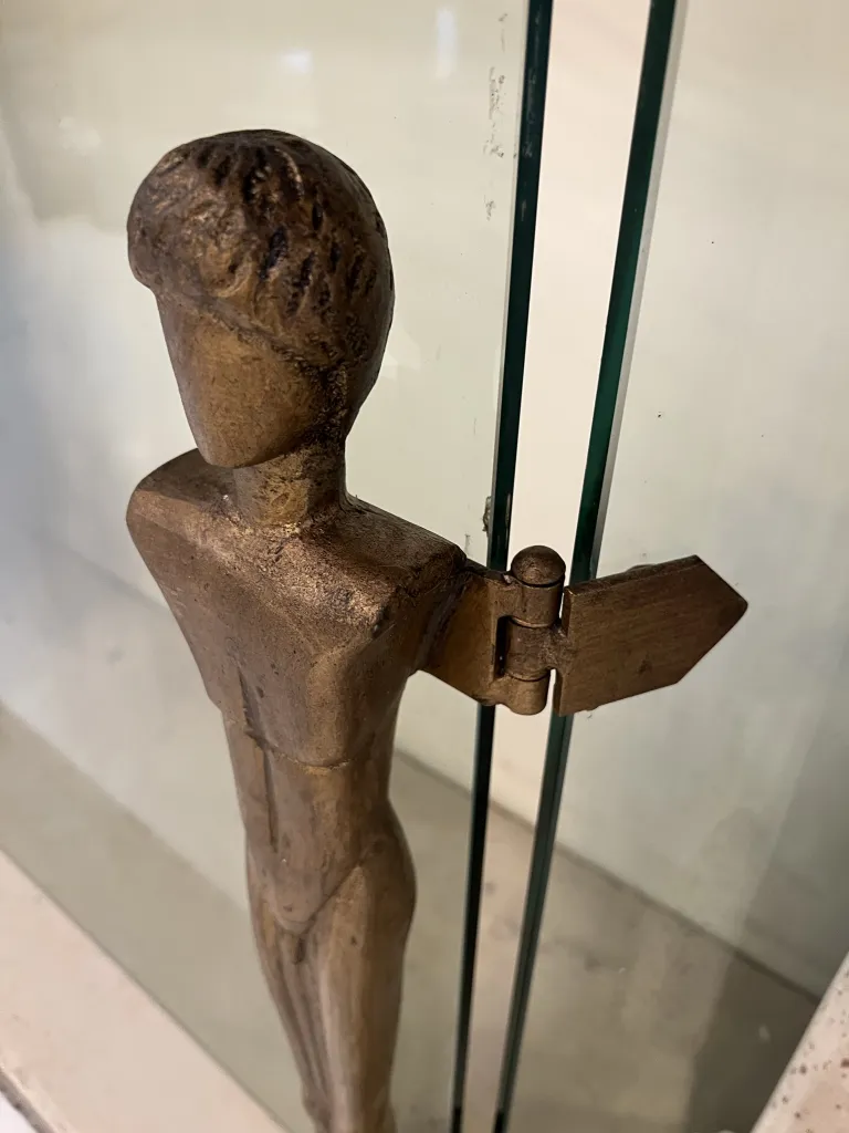 Antique fireplace front by Alberto Giacometti featuring a simple human figure