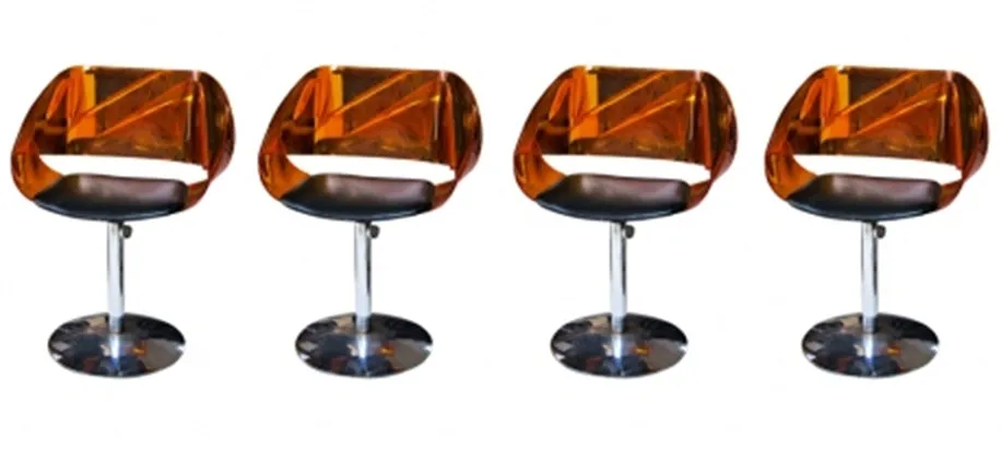 4 antique chairs with vibrant colors and comfortable seats placed in a modern setting