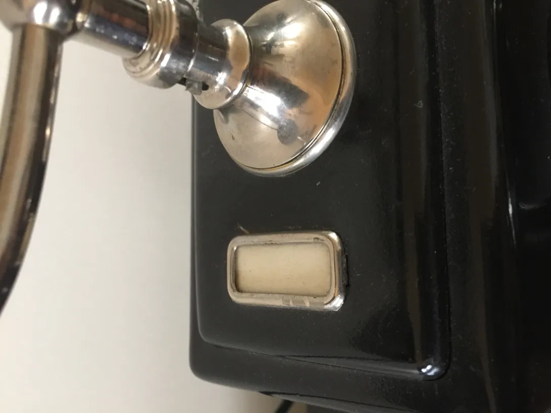 Antique classic phone in black with shiny details.