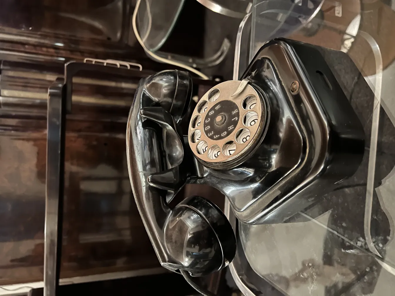 Classic antique phone in a vintage setting with dark background.