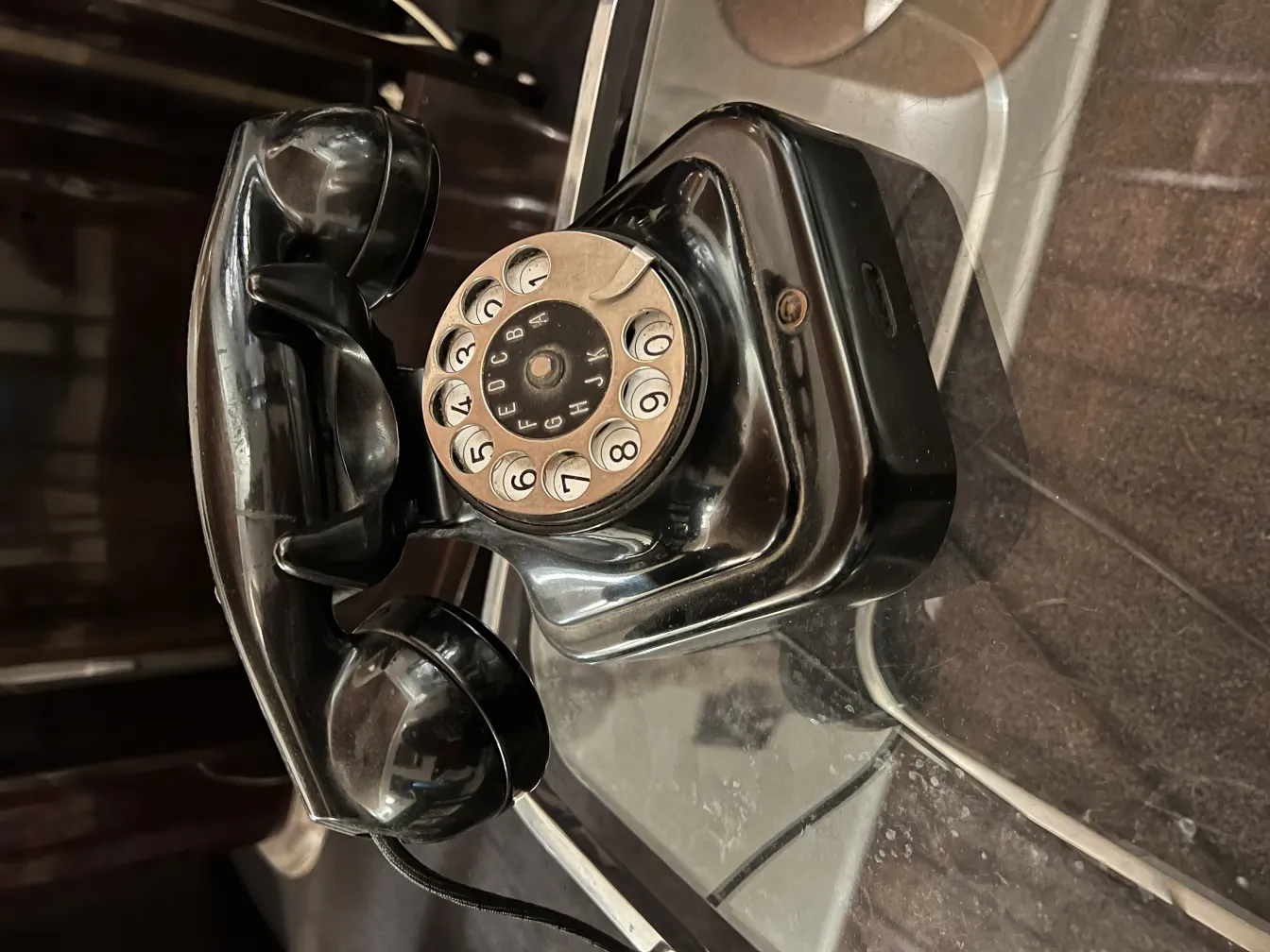 Classic antique phone with dial and receiver on dark background.