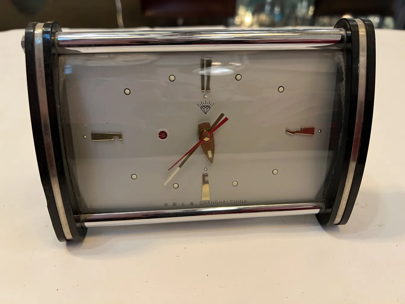 antique table clock with gold hands and white background