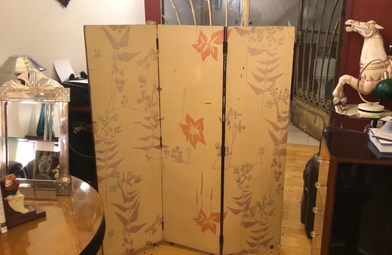 Antique folding screen with colorful flower designs on beige background.
