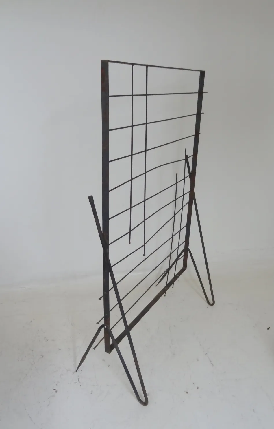 Antique folding screen with a simple design in dark color, perfect for dividing spaces.