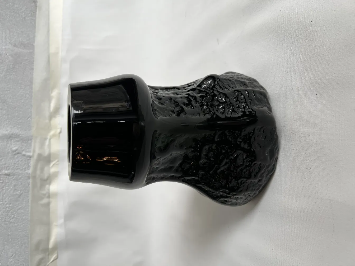 antique black vase with unique texture and design on white background