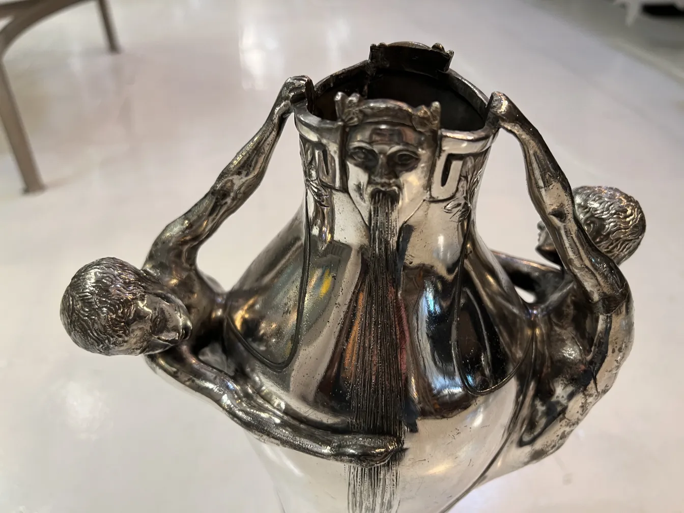 antique vase featuring sculpted figures, elegant decor