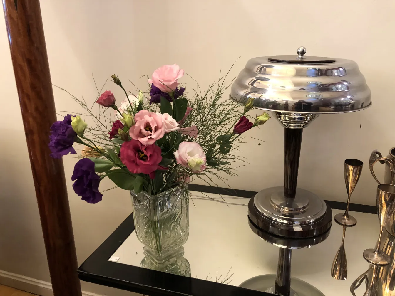 antique vase with bright flowers displayed on table
