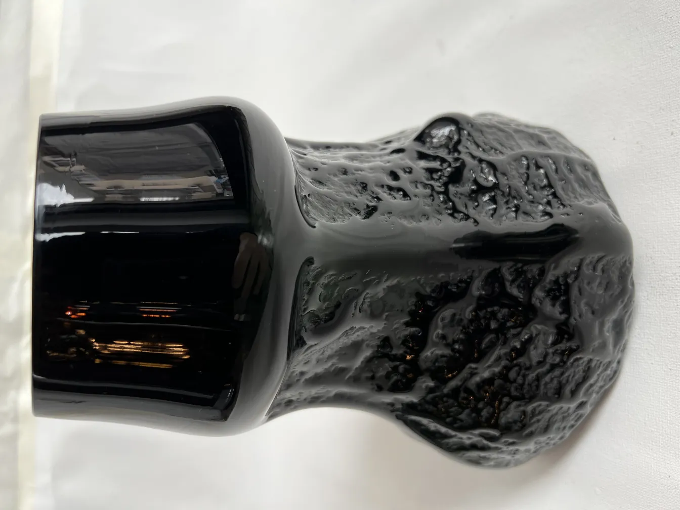 antique black vase with textured design and unique shape