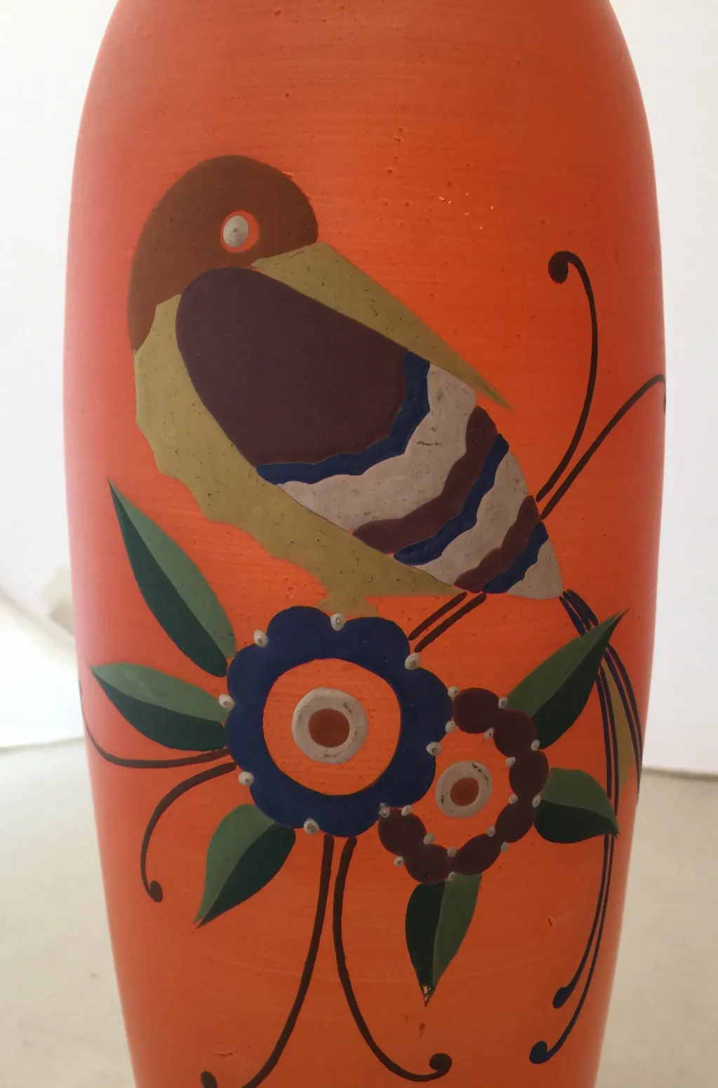 antique vase with floral and bird design in vibrant colors