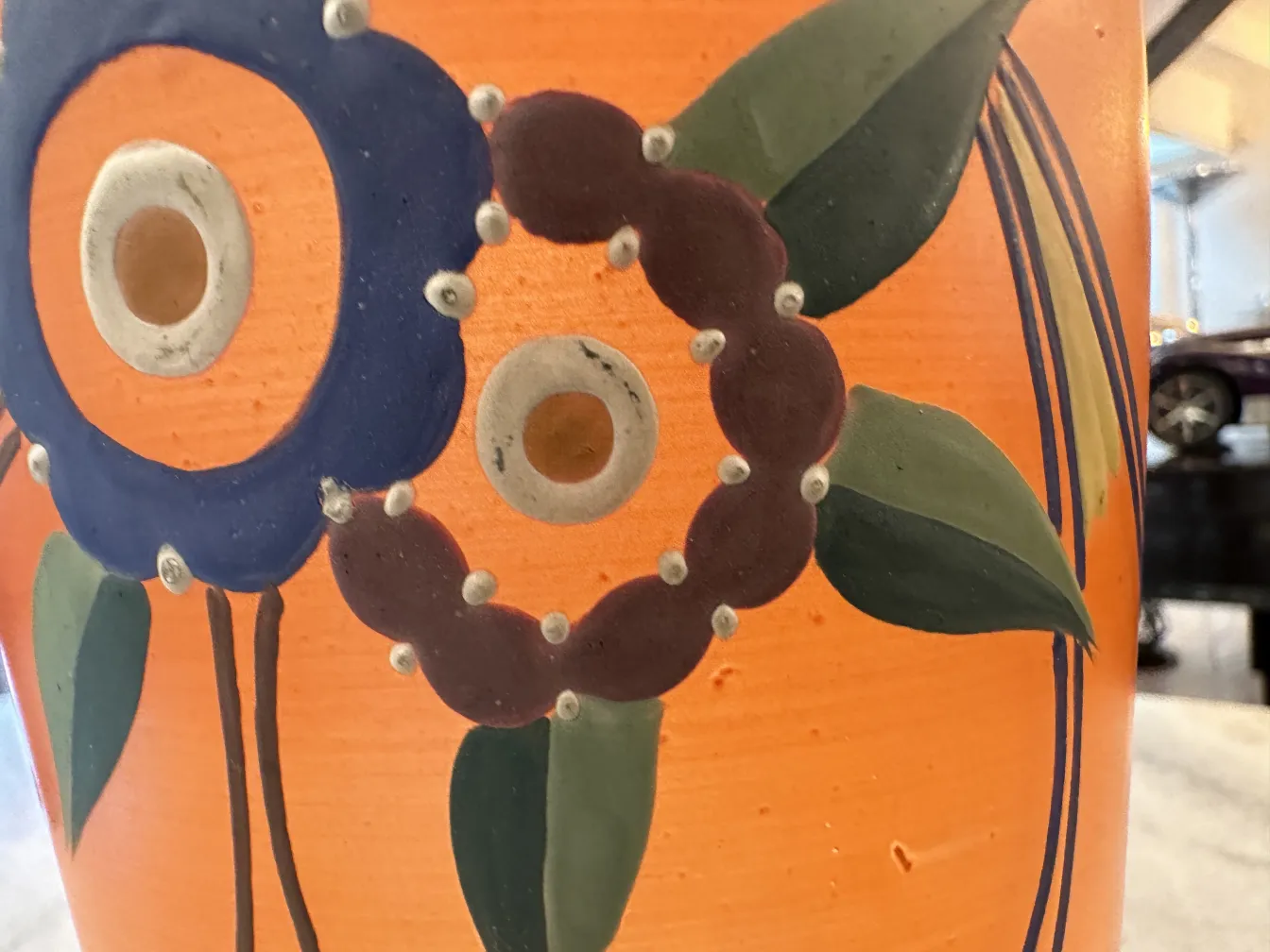 antique vase with floral painting, orange background