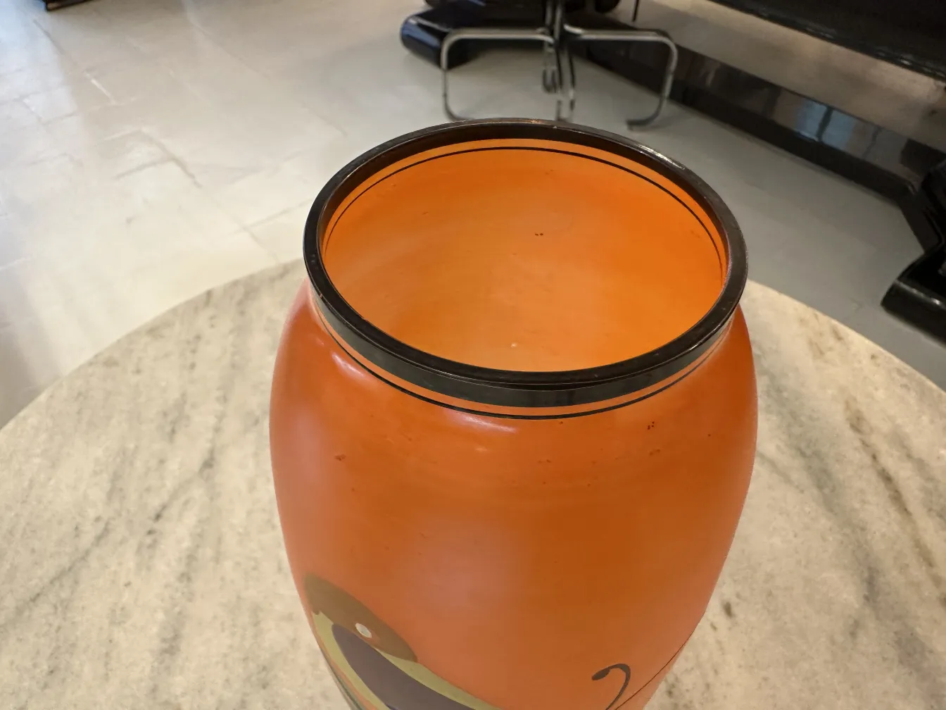 antique vase with rounded shape and orange color with decorations