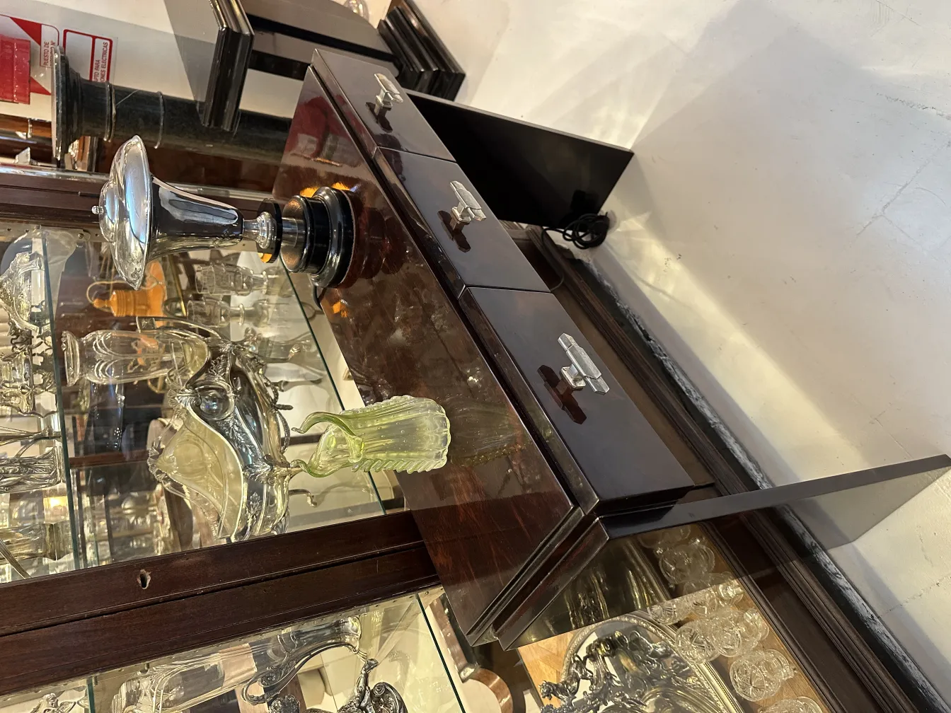 Antique green vase with ribbed details, surrounded by decorative objects