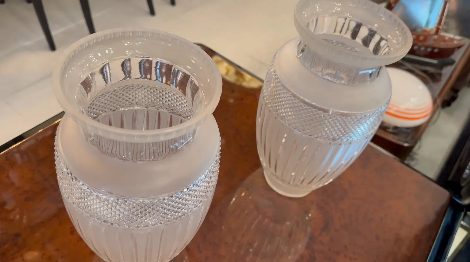 two antique vases with decorative details in an elegant setting