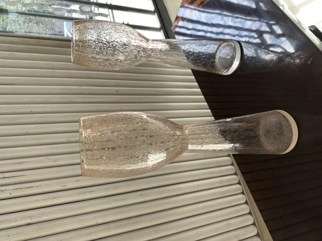 Two antique decorative vases on a table with a light background