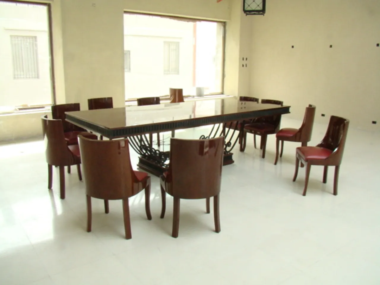 Antique Art Deco dining table for 12 people in a minimalist setting.
