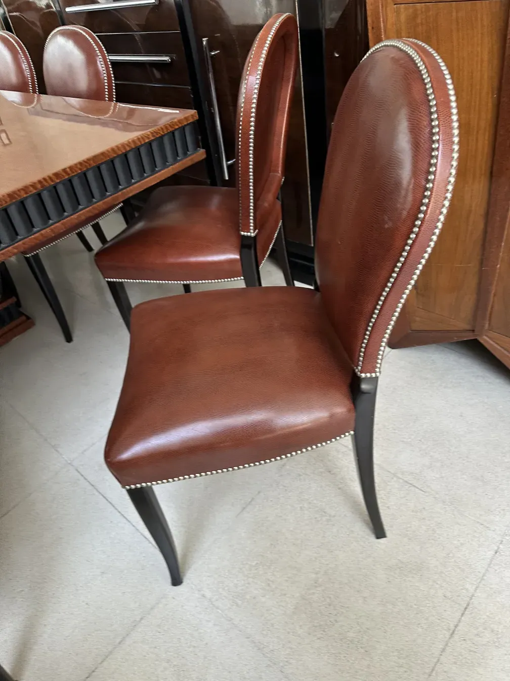 Tavolo da pranzo antico art deco per 12 persone in un ambiente elegante con sedie abbinate.