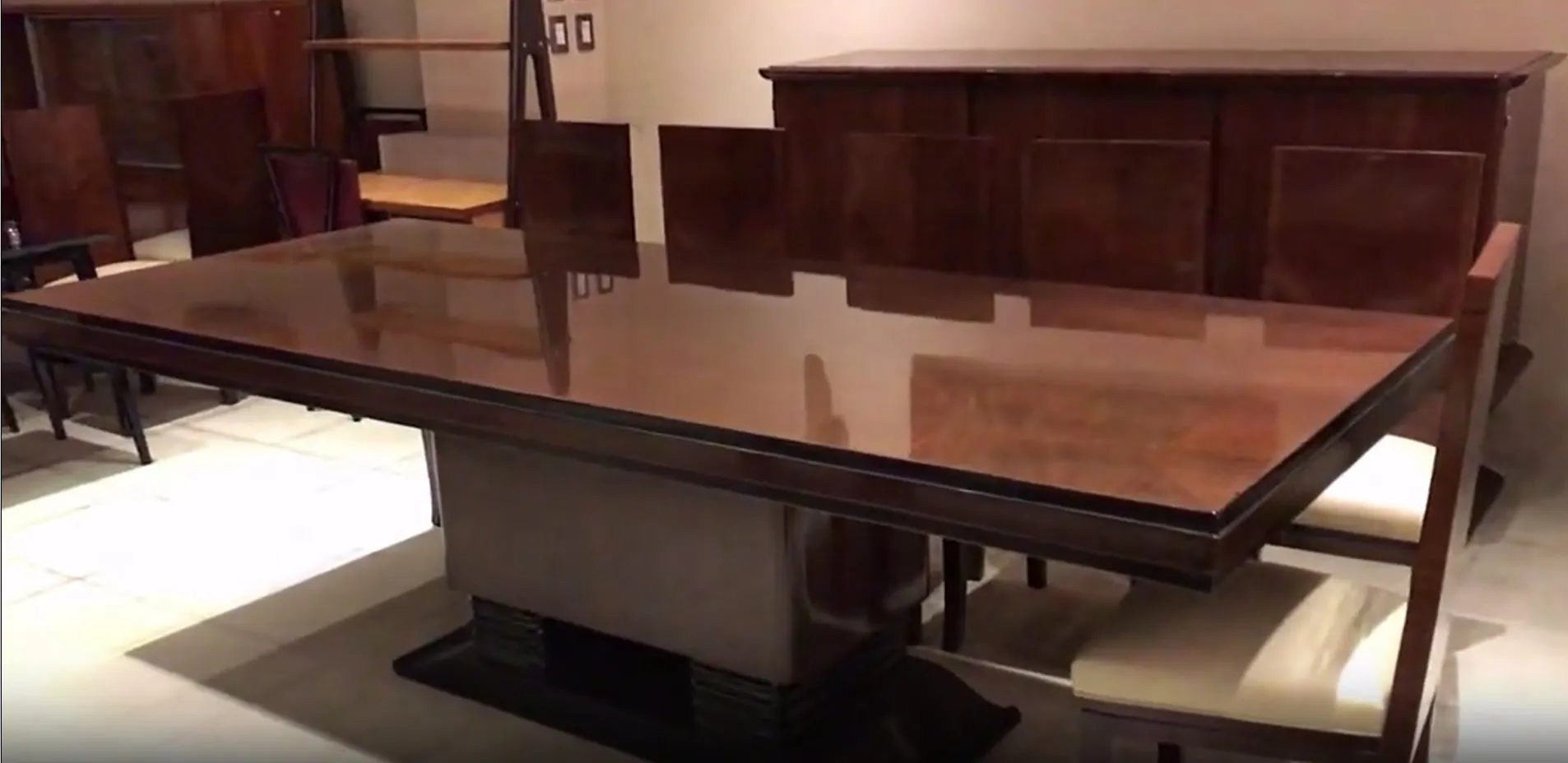 antique dining table with a shiny finish for ten people.