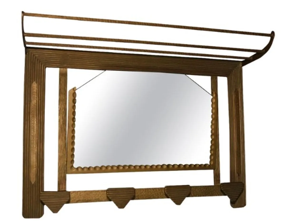 Antique coat rack with a decorative mirror on top