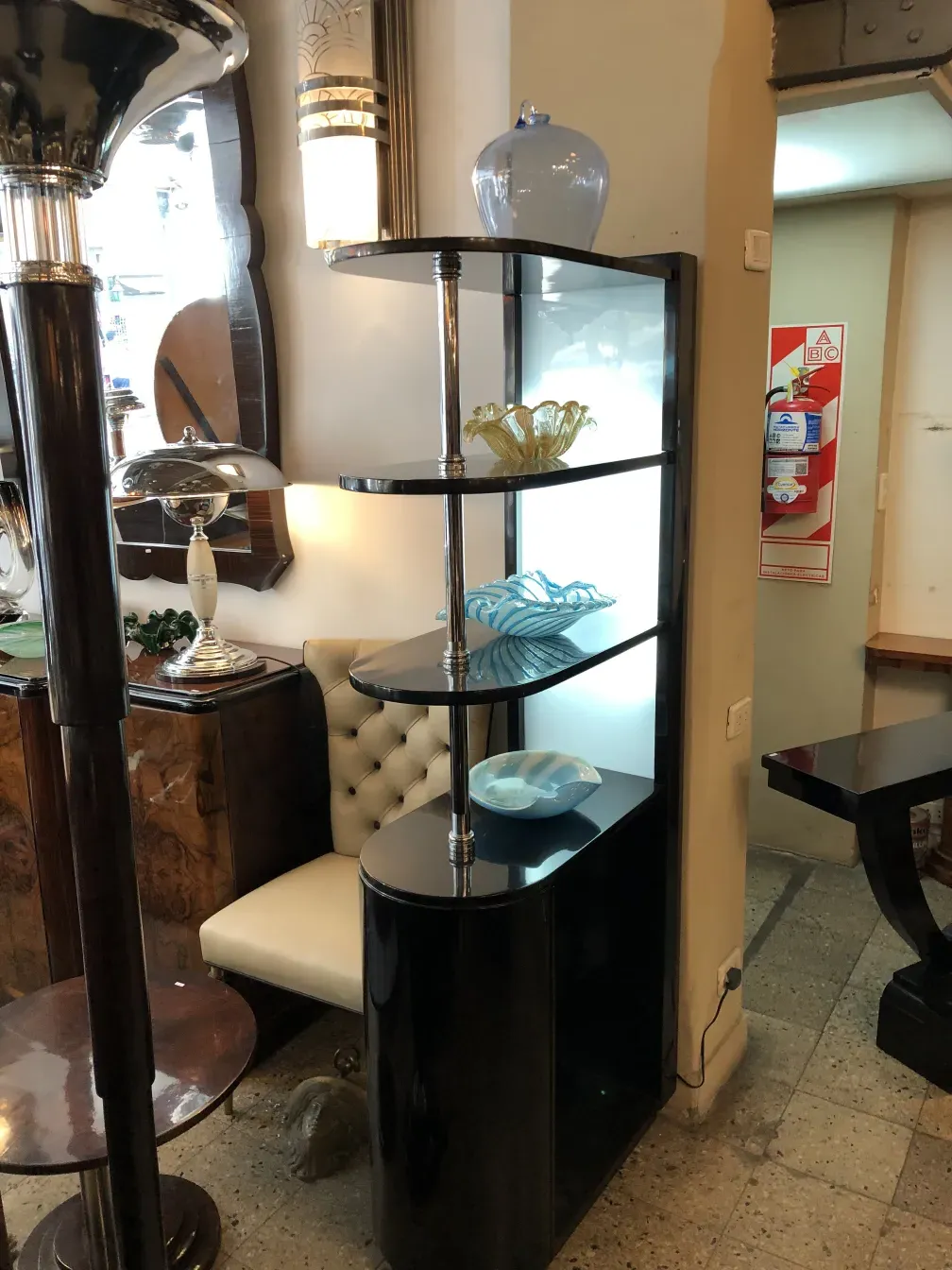 Antique bar cabinet with elegant chrome details.