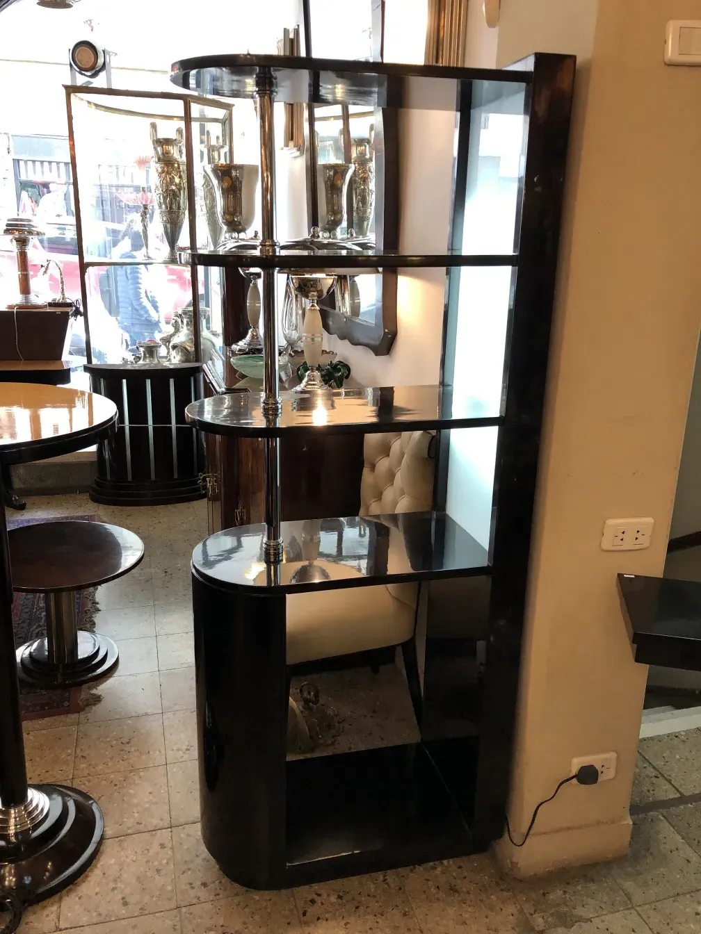 Mueble bar antiguo con acabados en negro en un entorno elegante.