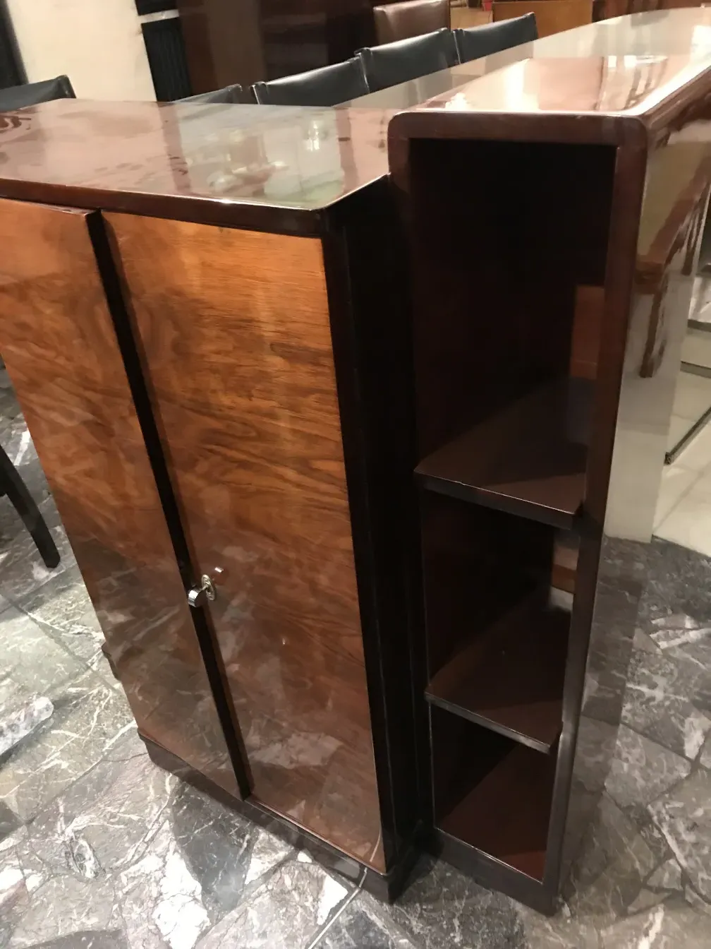Antique wooden bookcase with visible shelves, elegant setting
