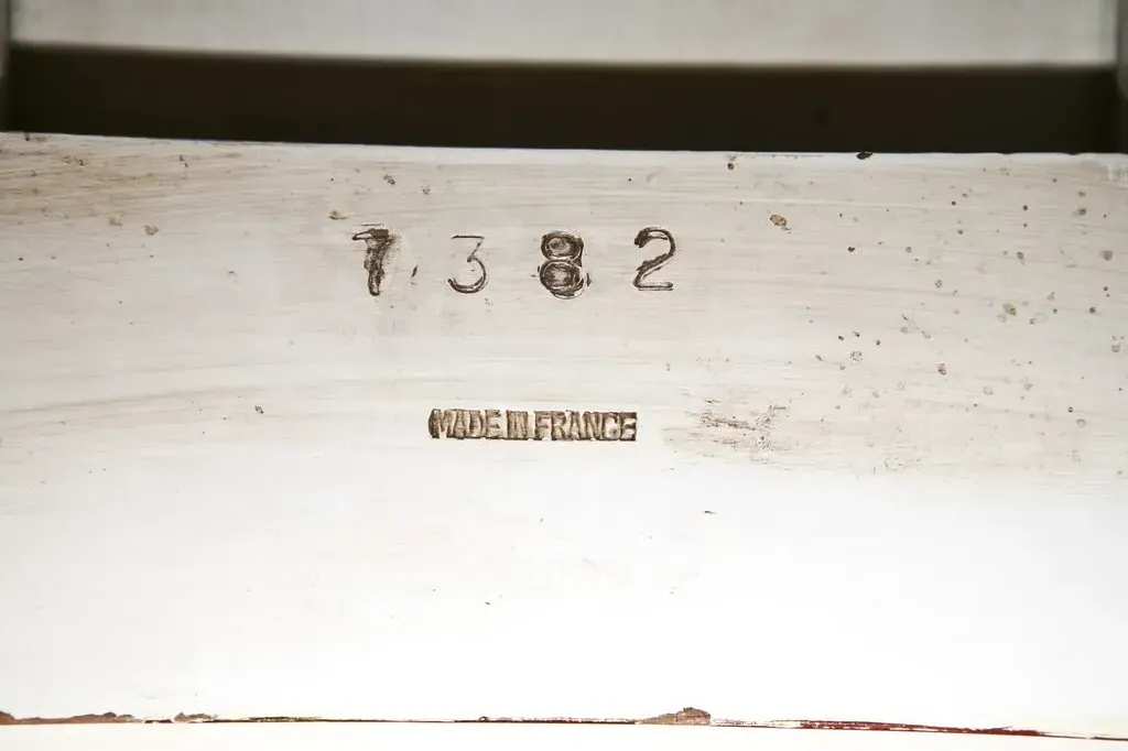 Antique desk featuring inscriptions on the surface.