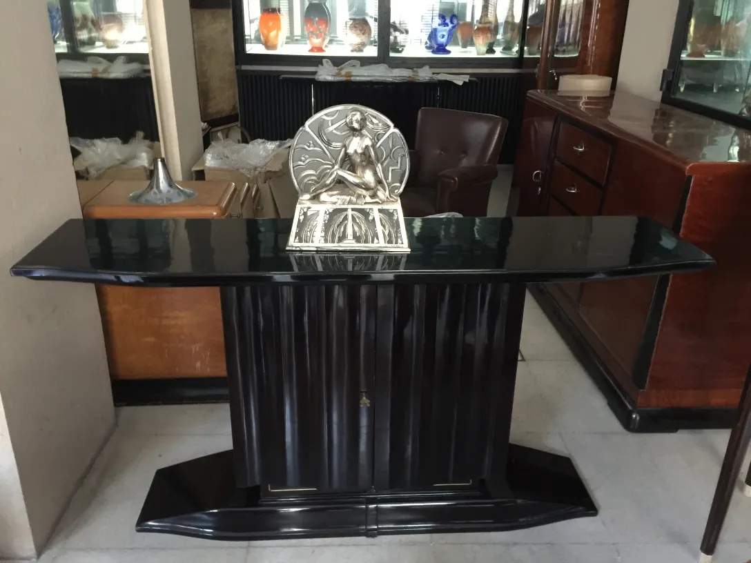 two elegant antique consoles with detailed decoration, in a classic setting