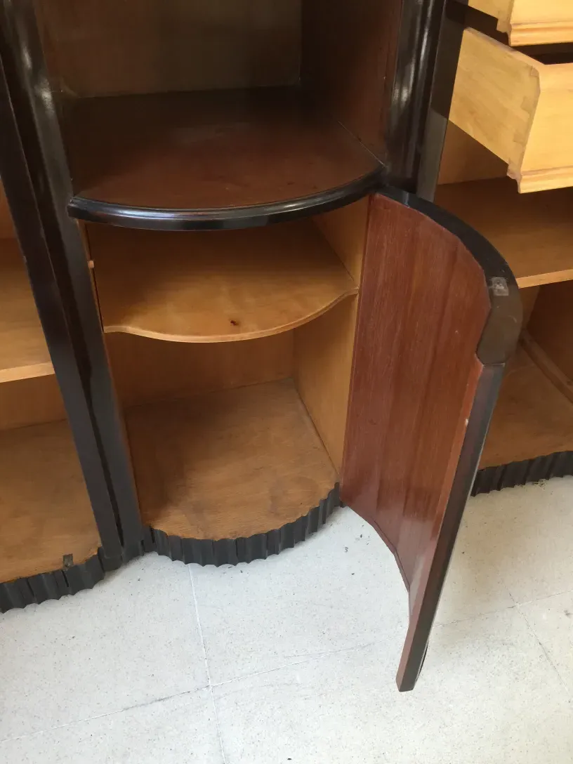 antique bookcase with curved shelves in a cozy setting