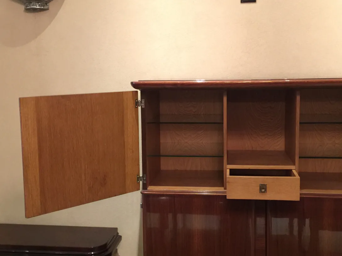 Antique bookcase with shelves and a small drawer.