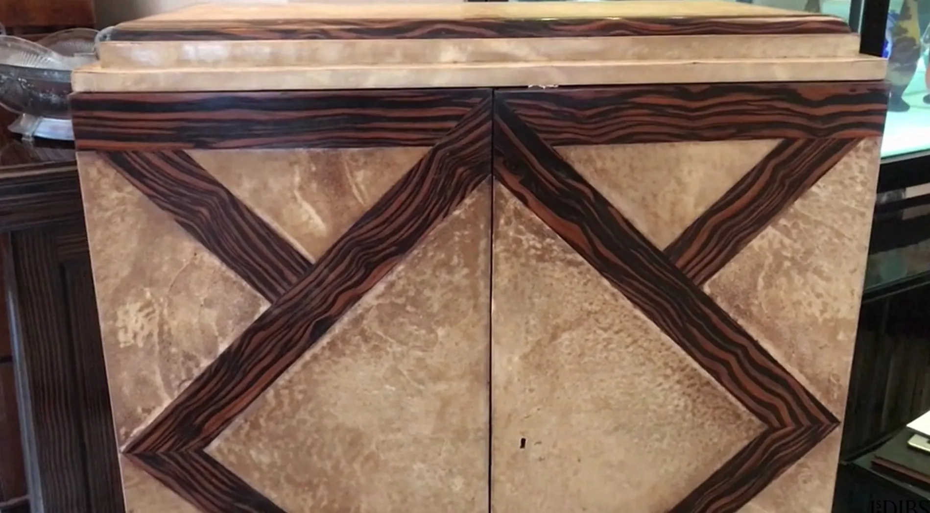 Antique bookcase with geometric design, featuring dark and light color details, suitable for vintage decor.