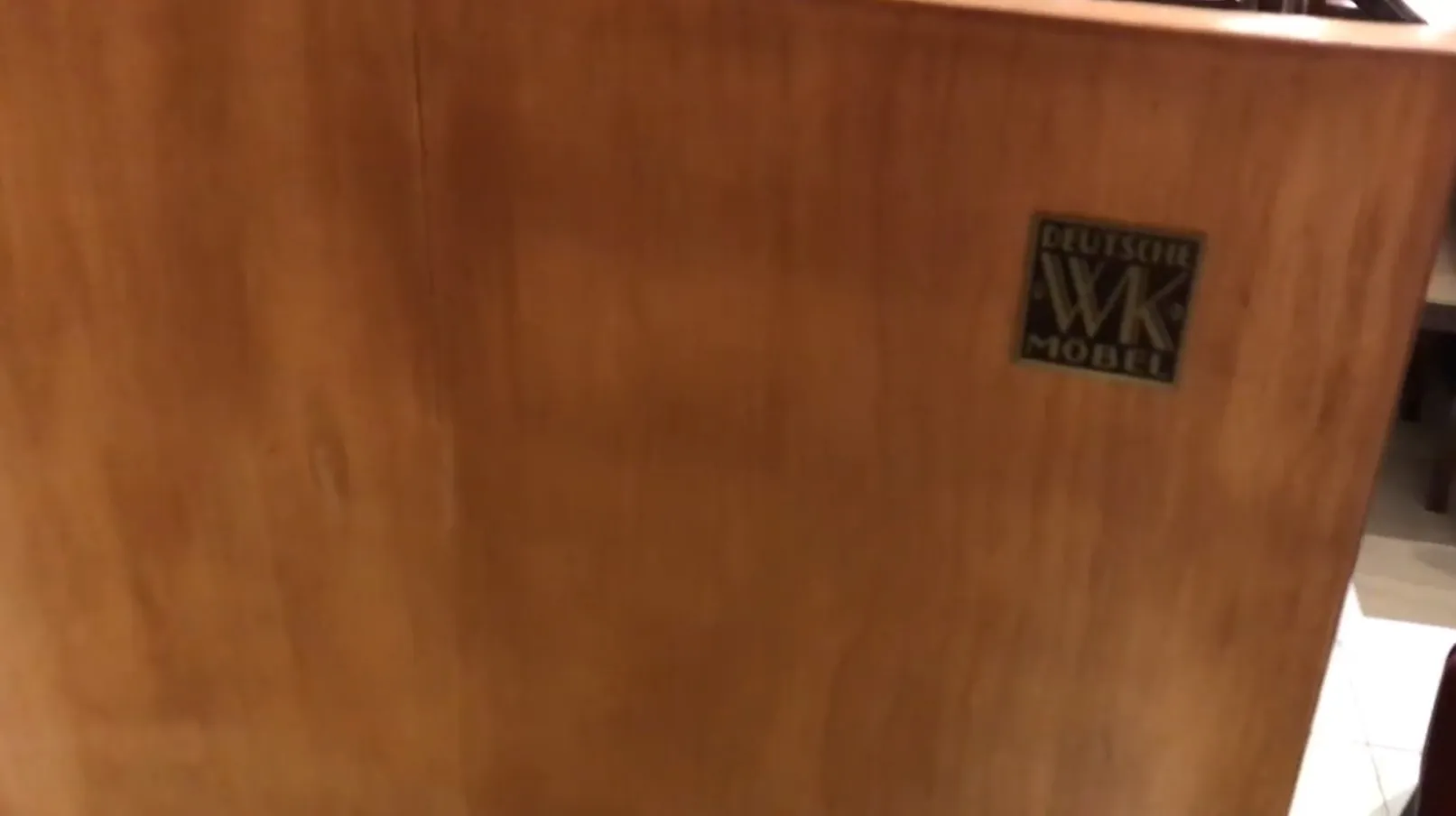 Antique bookcase featuring Deutsche WK Mobel logo, stylish design.