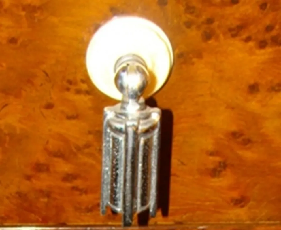 Antique decorative column with elegant design, wooden background.