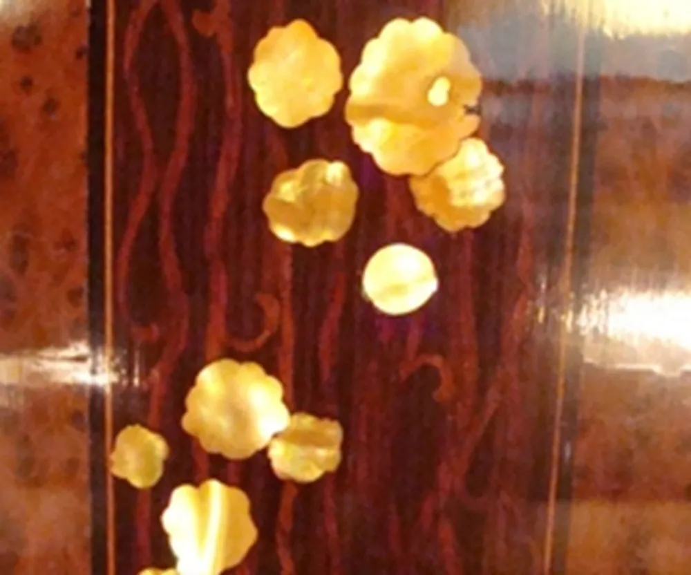 antique column decorated with yellow details on dark background