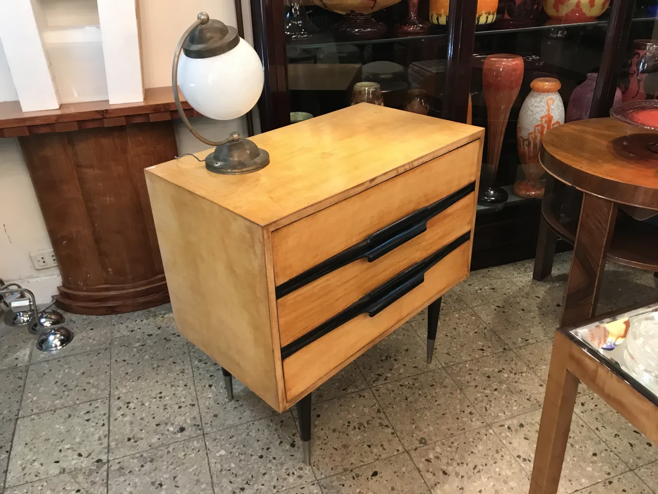 comodino antico con design elegante e lampada accanto